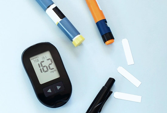 Various T1D devices are laid out on a table.