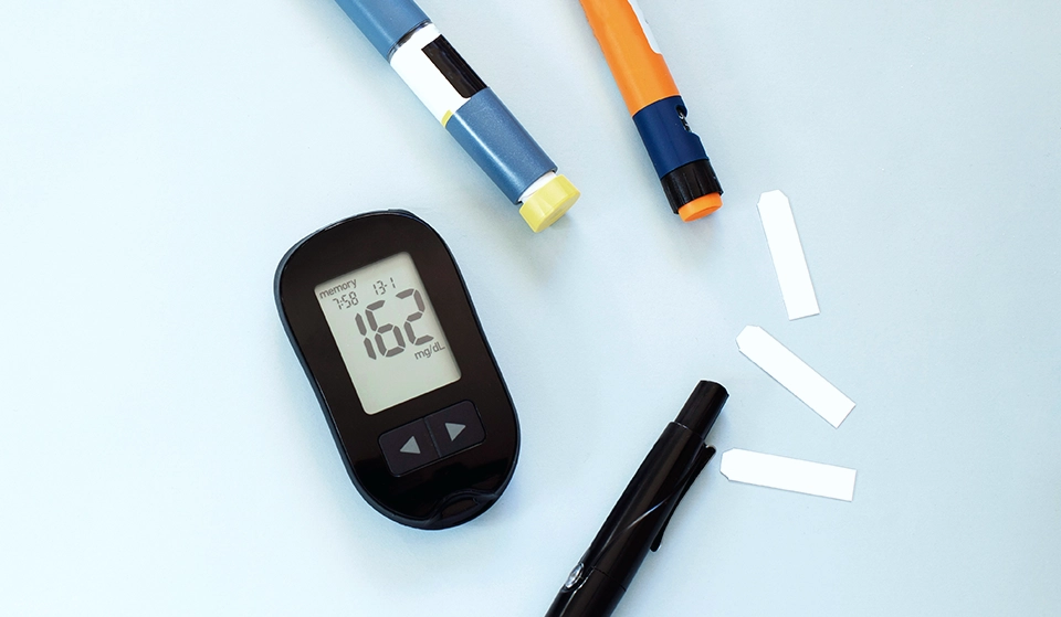 Various T1D devices are laid out on a table.